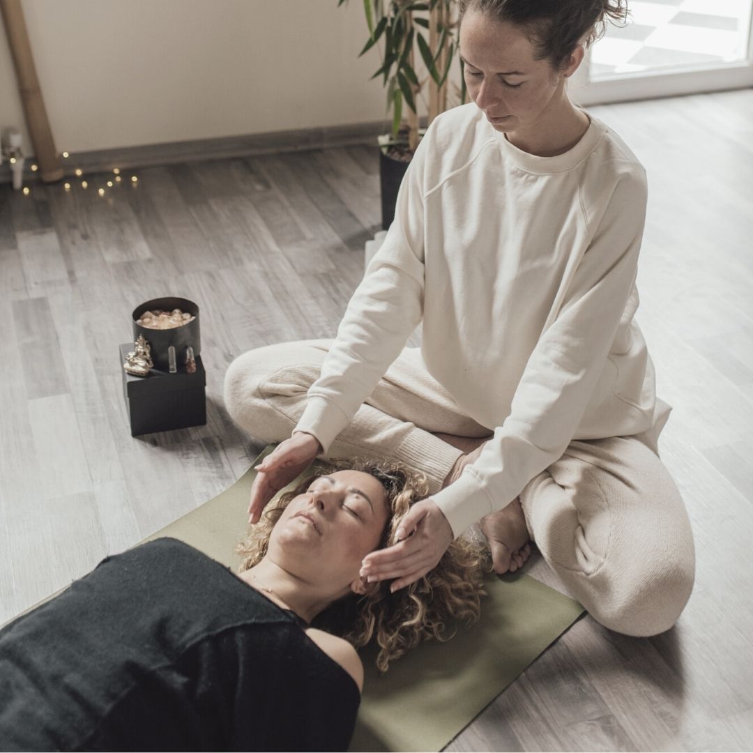 Woman giving reiki to a client